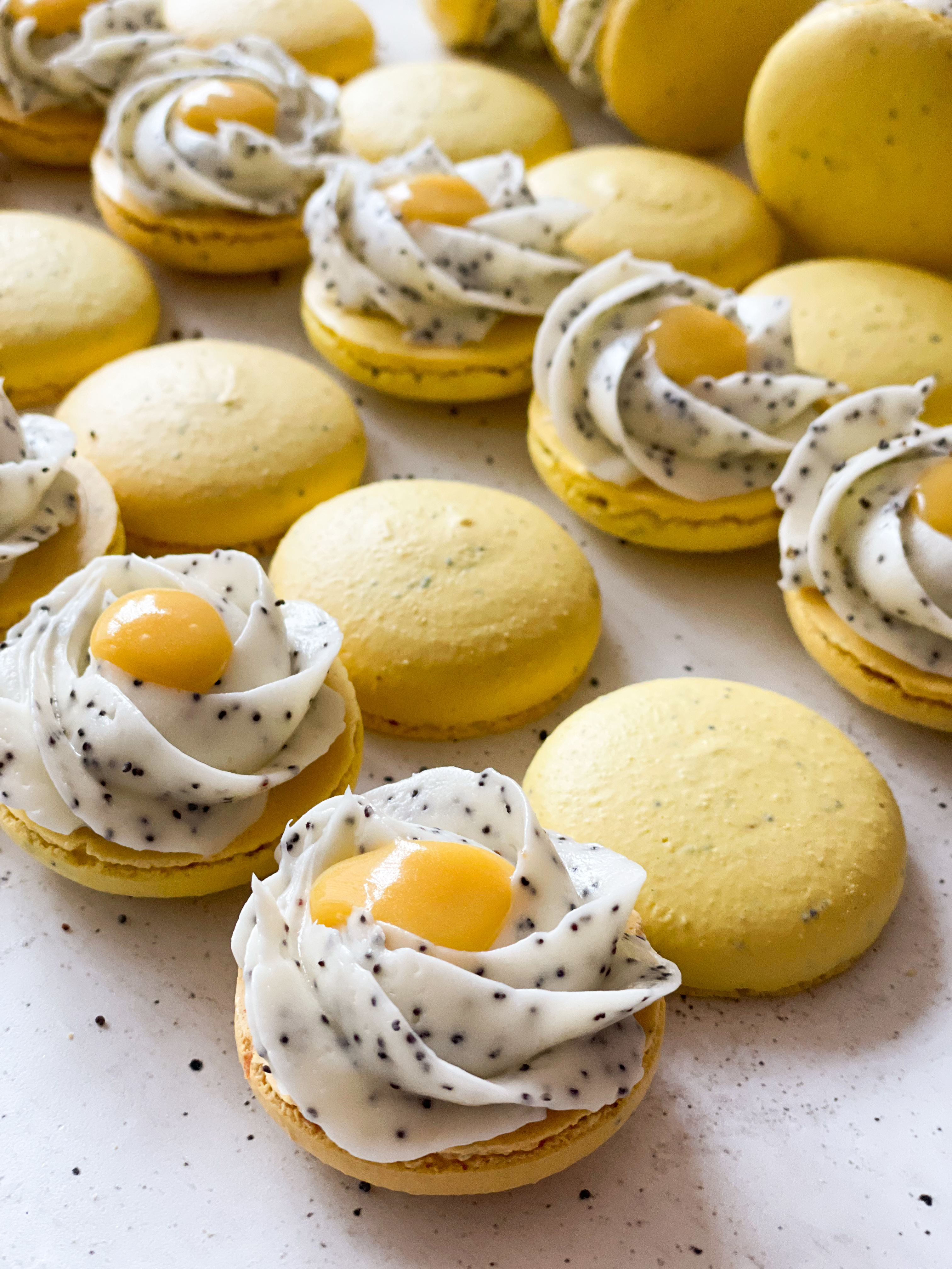 Poppyseed macarons with passionfruit curd
