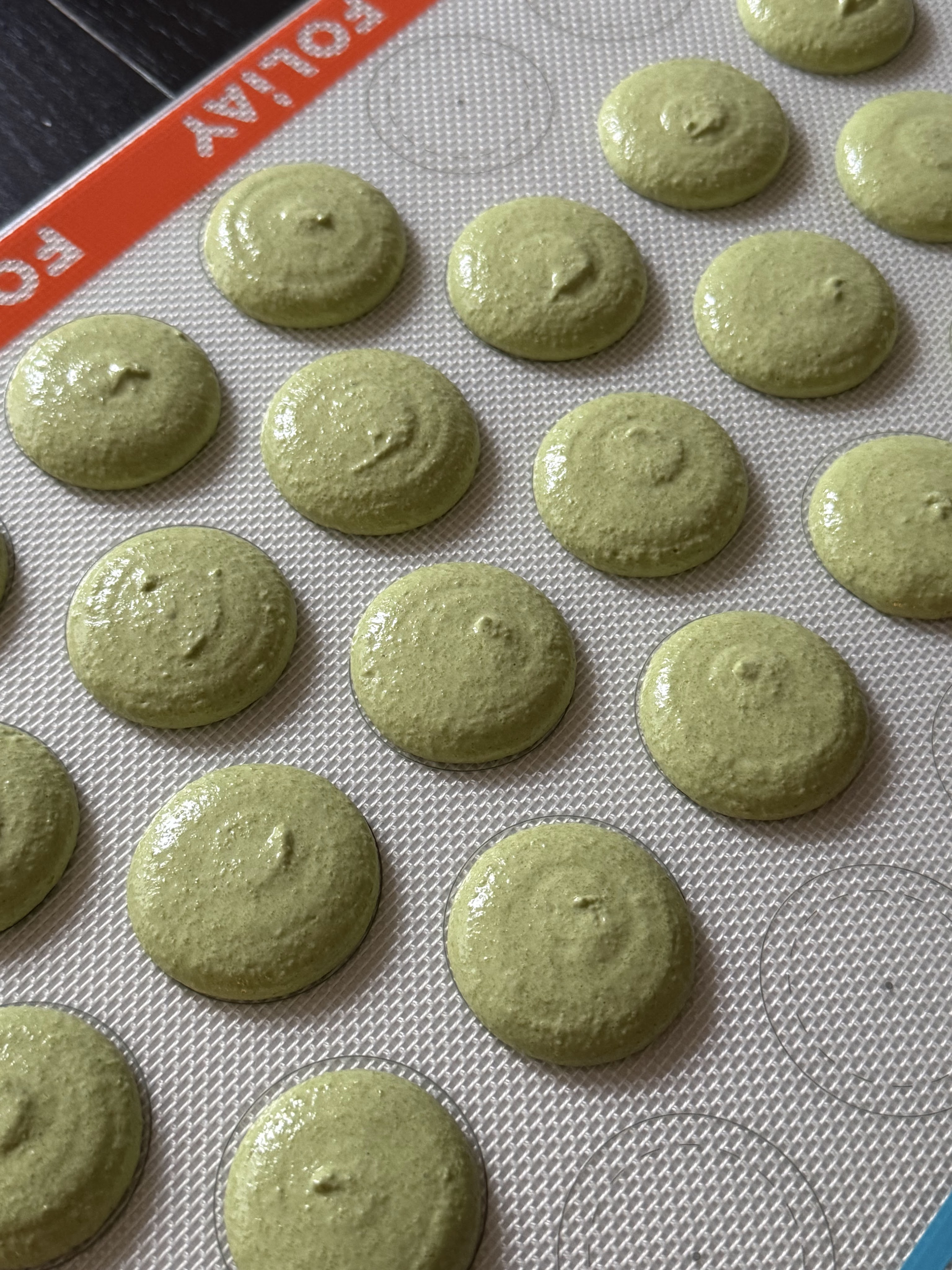 Matcha macaron shells pefore bake