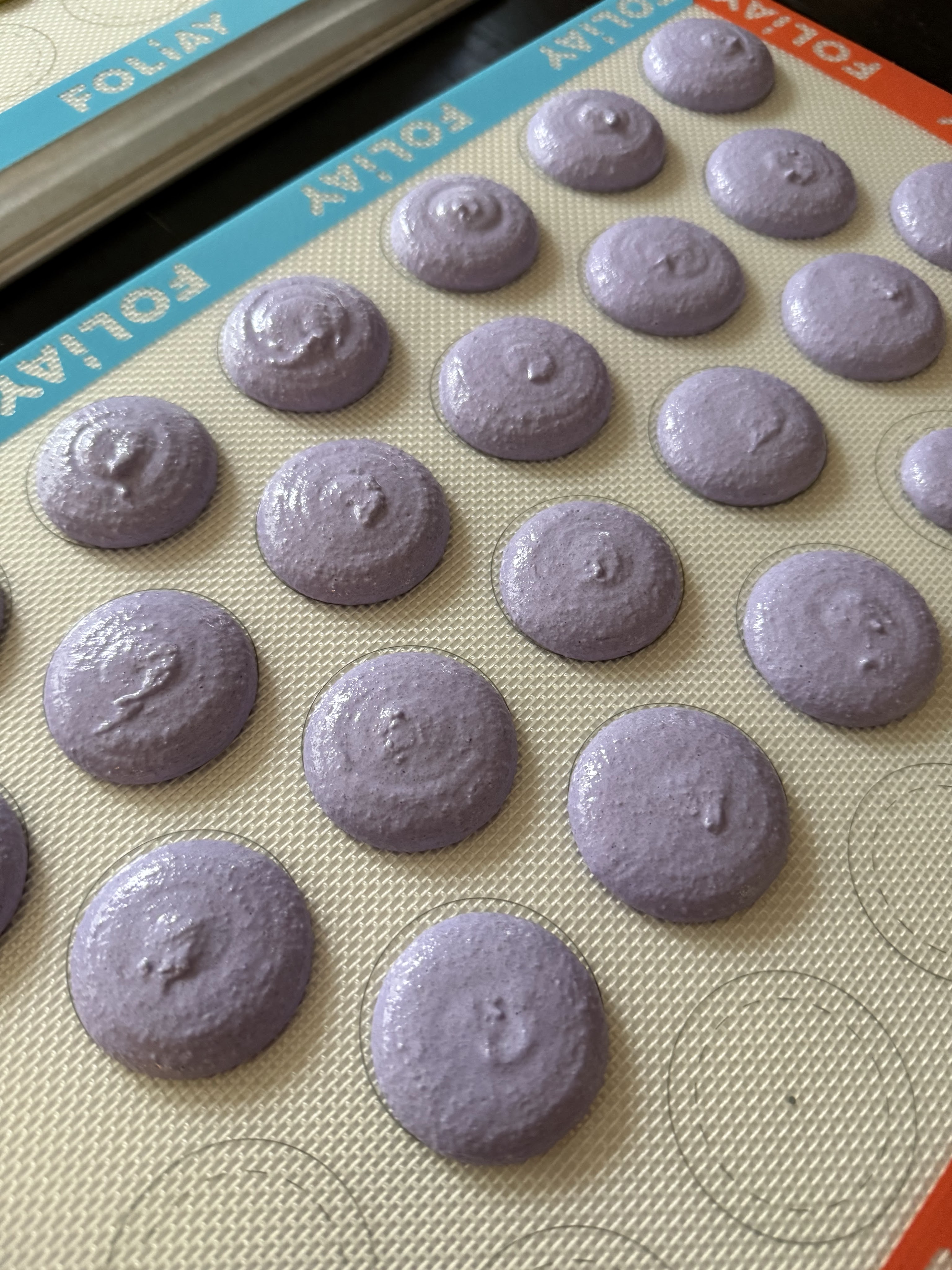 Lavender macaron shells before bake