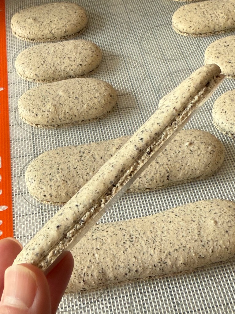 Black sesame macaron shell after bake