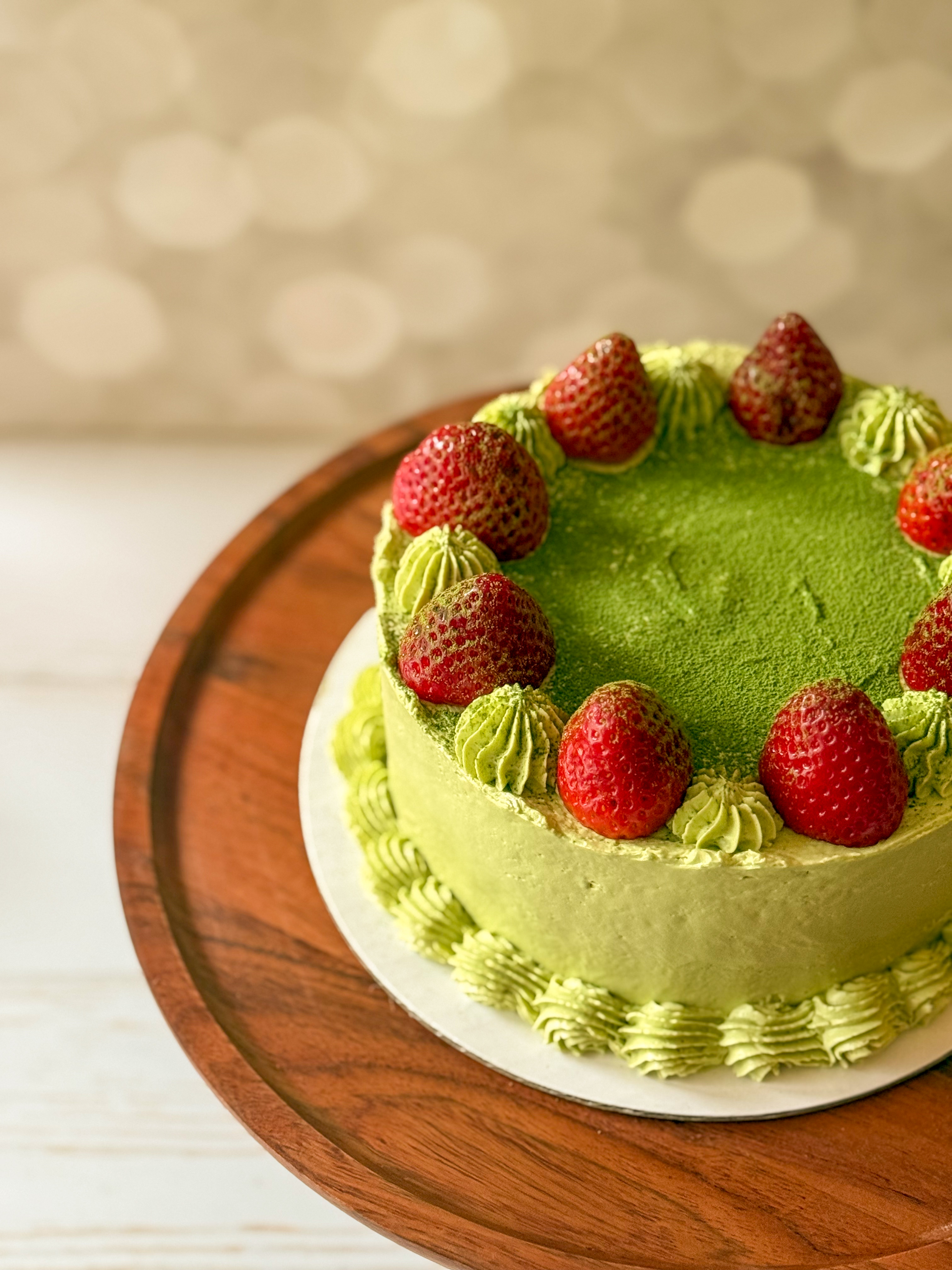 Vanilla chiffon cake filled with strawberry jam and fresh strawberries and frosted with matcha Swiss meringue buttercream.